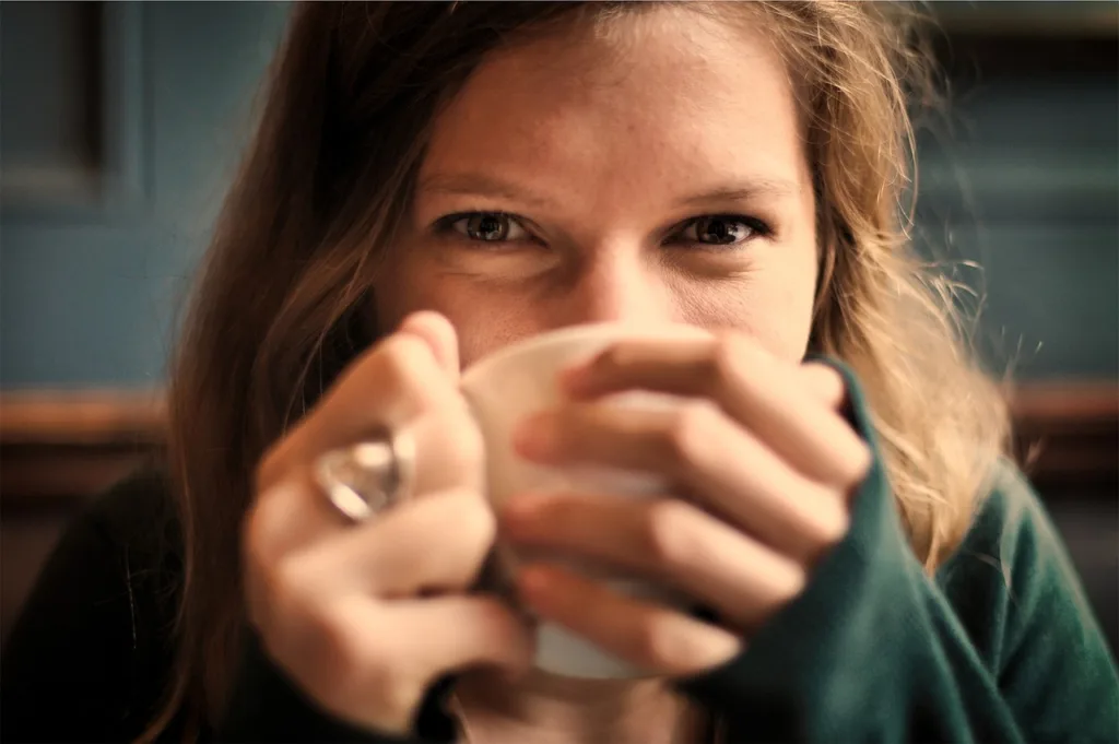 girl, woman, smile, smiling, happy, coffee, tea, cup, drinking, eyes, people, cozy, comfortable, relaxed, sipping, tea cup, brown coffee, brown happy, brown relax, brown tea, brown smile, coffee cup, brown eye, brown happiness, brown cup